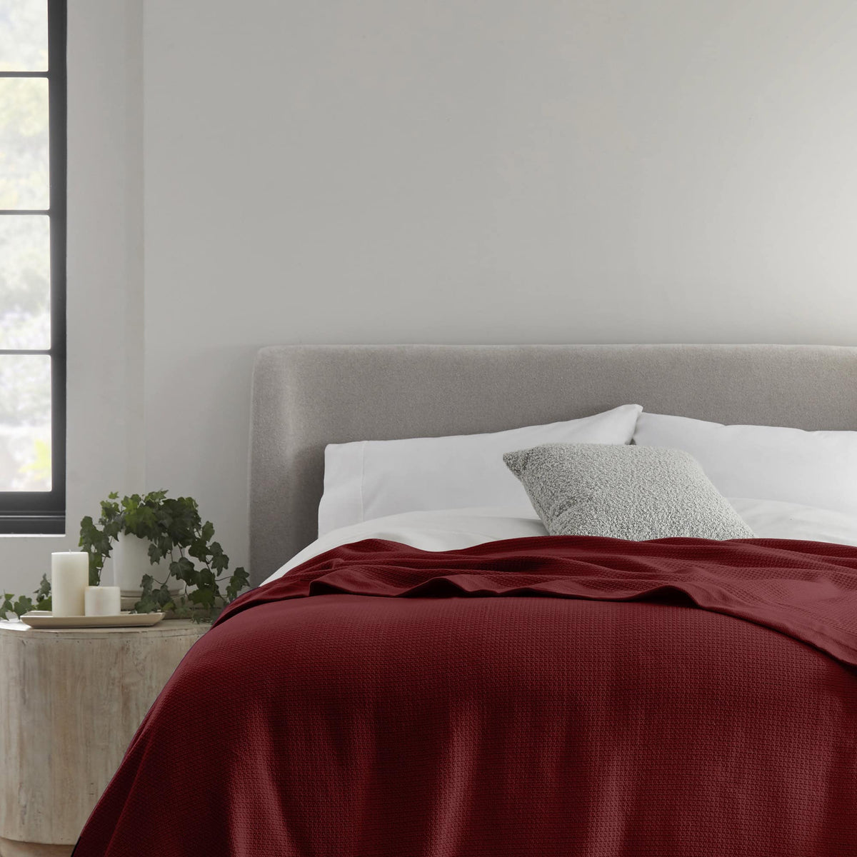 Whisper Organics Organic Cotton Woven Blanket, Burgundy – on a bed