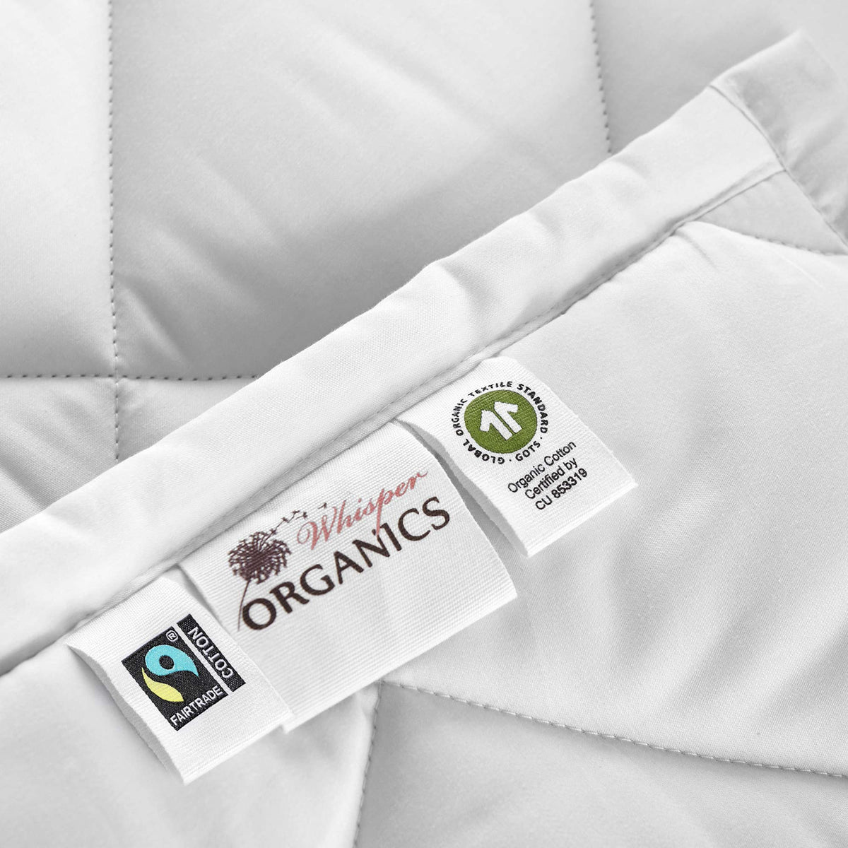 Close-up of Whisper Organics comforter labels: Fairtrade Cotton and GOTS organic cotton tags